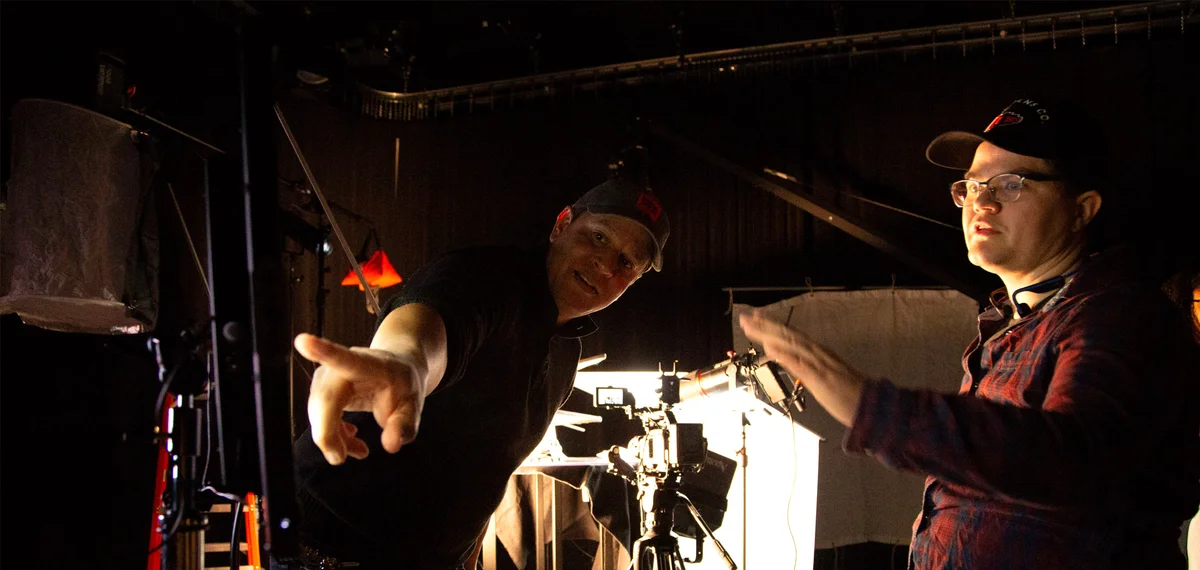 Student and professor working on set during a production class.