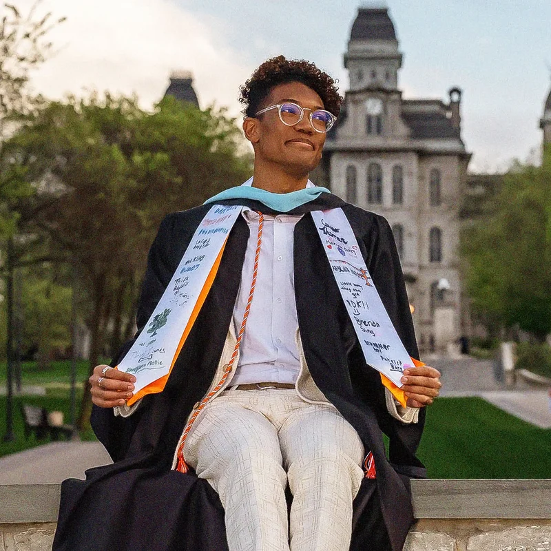 seb melendez poses in his graduation stole