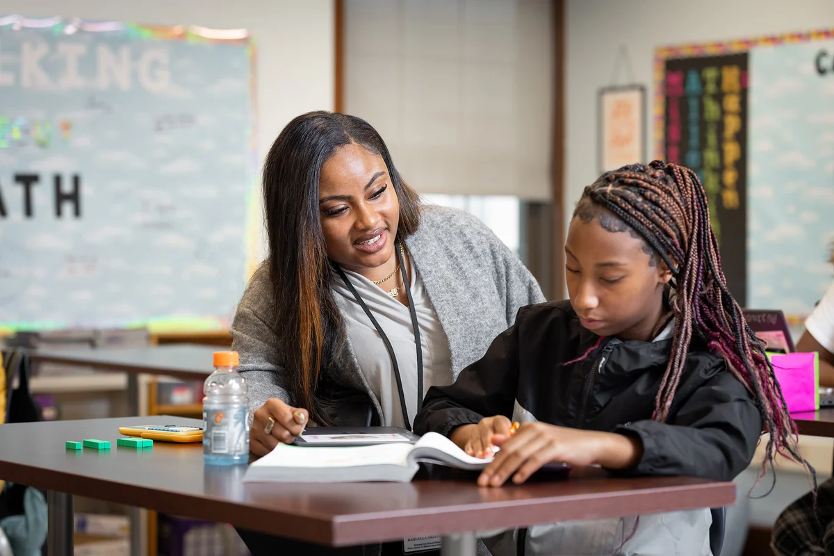 A School of Education teacher preparation student teaches a young student