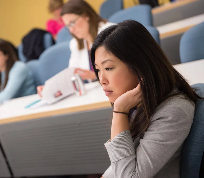 A student in the media studies program sitting and listening to a lecture.