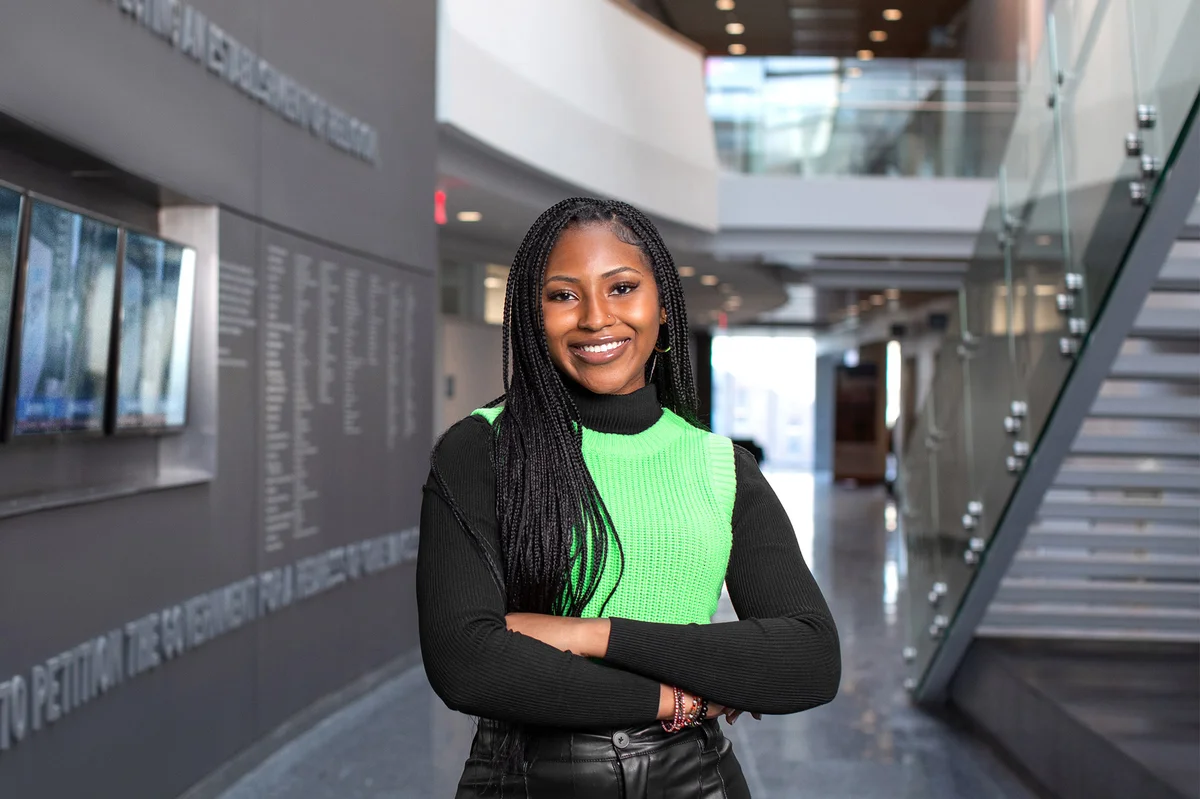 Mariama Jollah standing in the lobby of the Newhouse 3 building