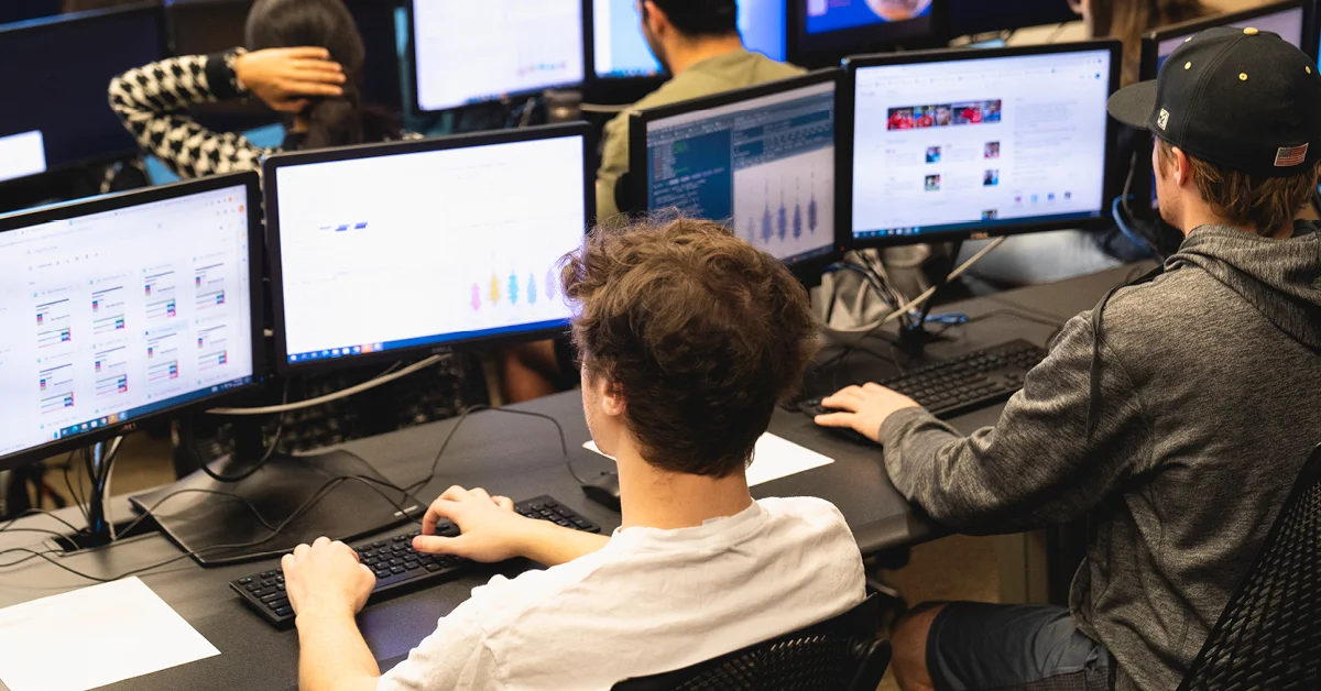 male student typing on computer