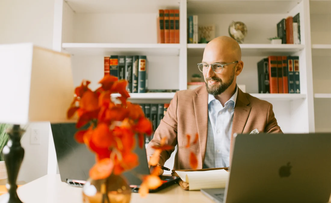 A student logs on to do coursework in his home office.