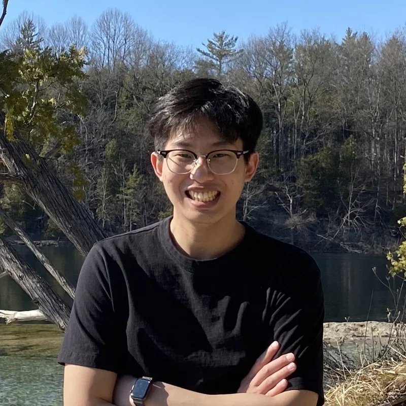 a photo of Seungchan Kim standing outside and smiling