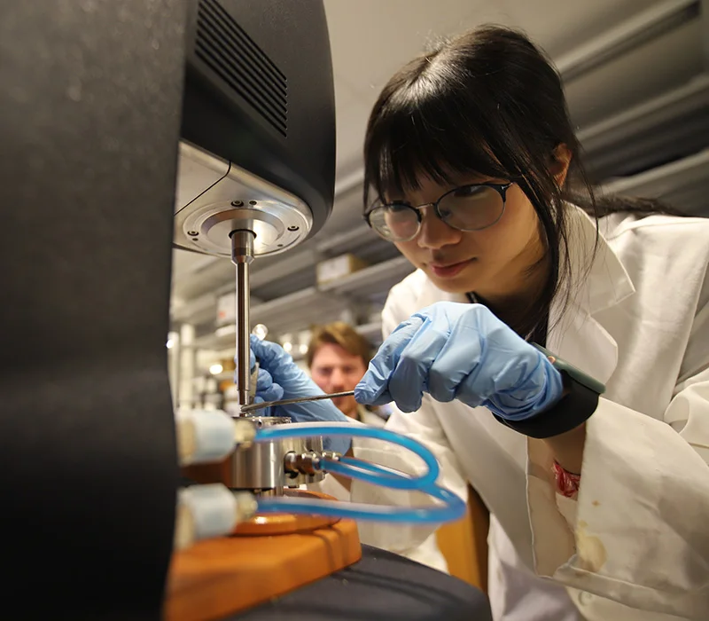 Student connecting wires and working on an engineering project.