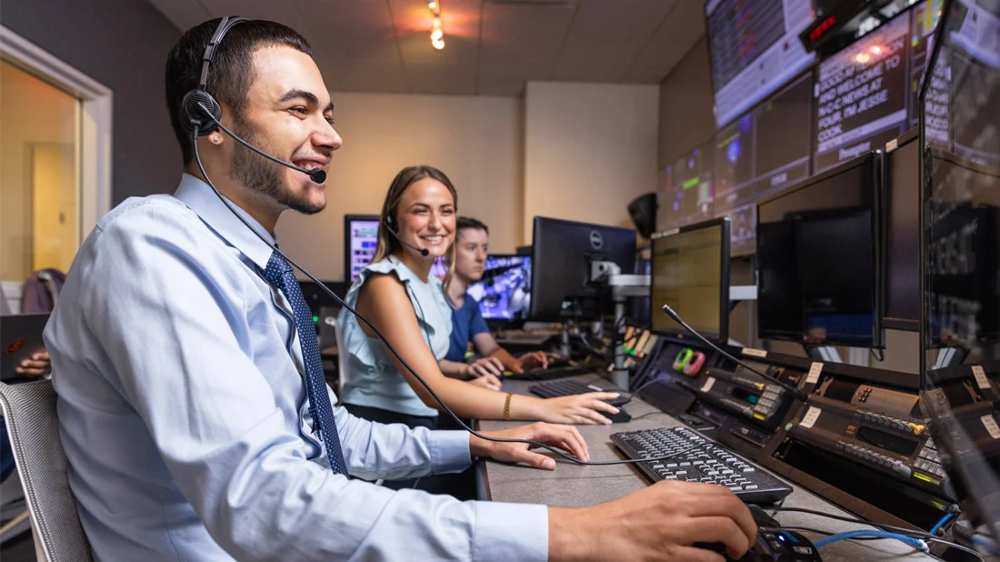 Students operating in the control room inside the Dick Clark Studio.