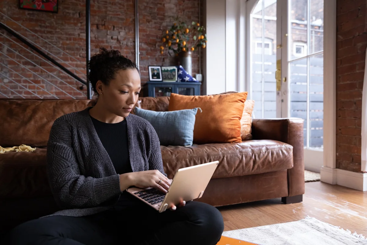 student on laptop in living room