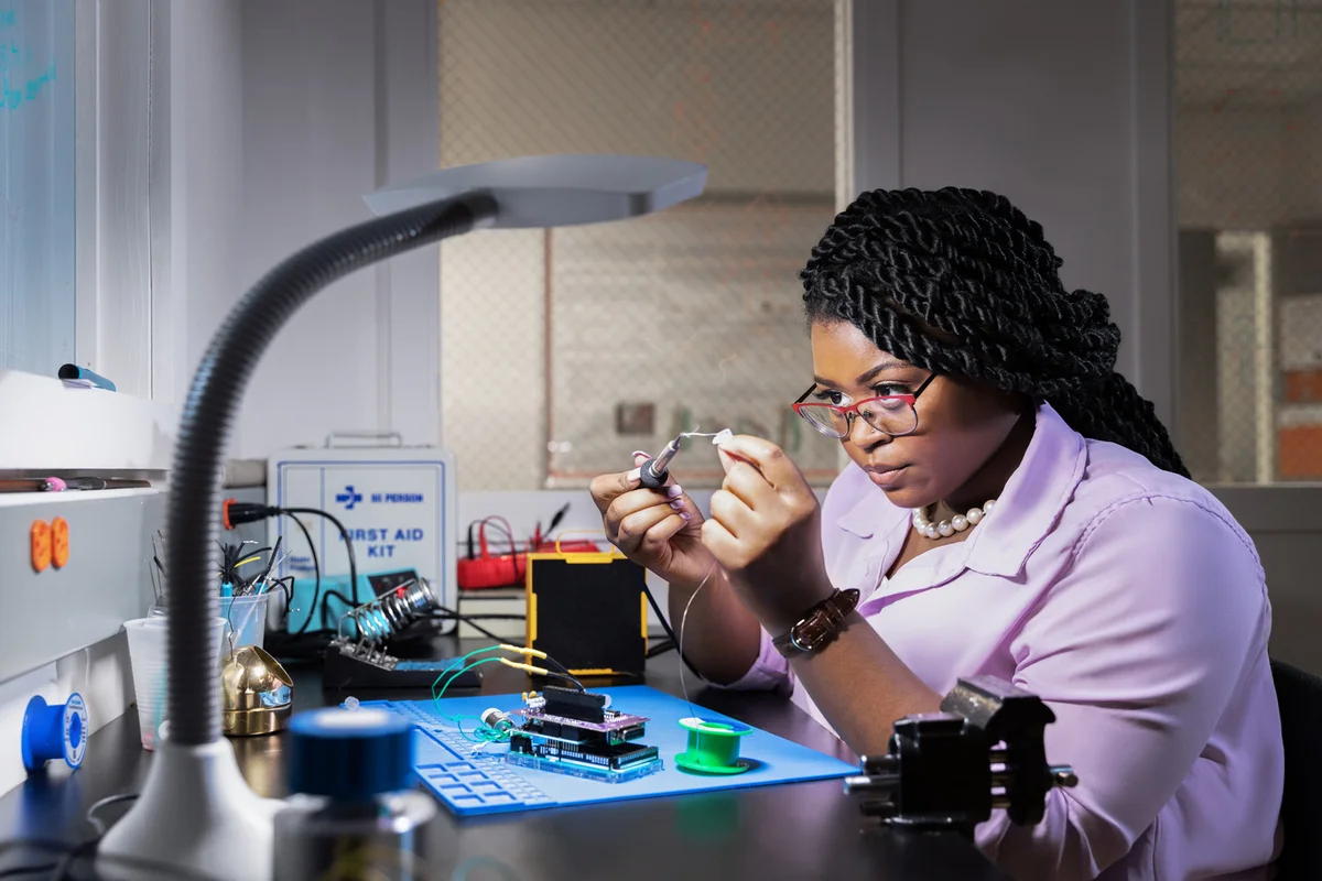 Jazmine Richardson, a recent biotechnology graduate, working on a device in a biotechnology lab
